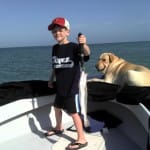 A boy, a dog and a sea trout.